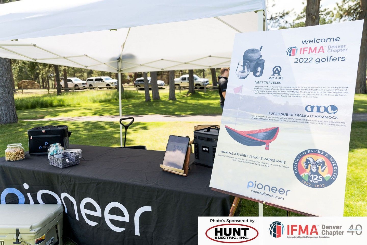 Table set up for a golf event with a sign that says 