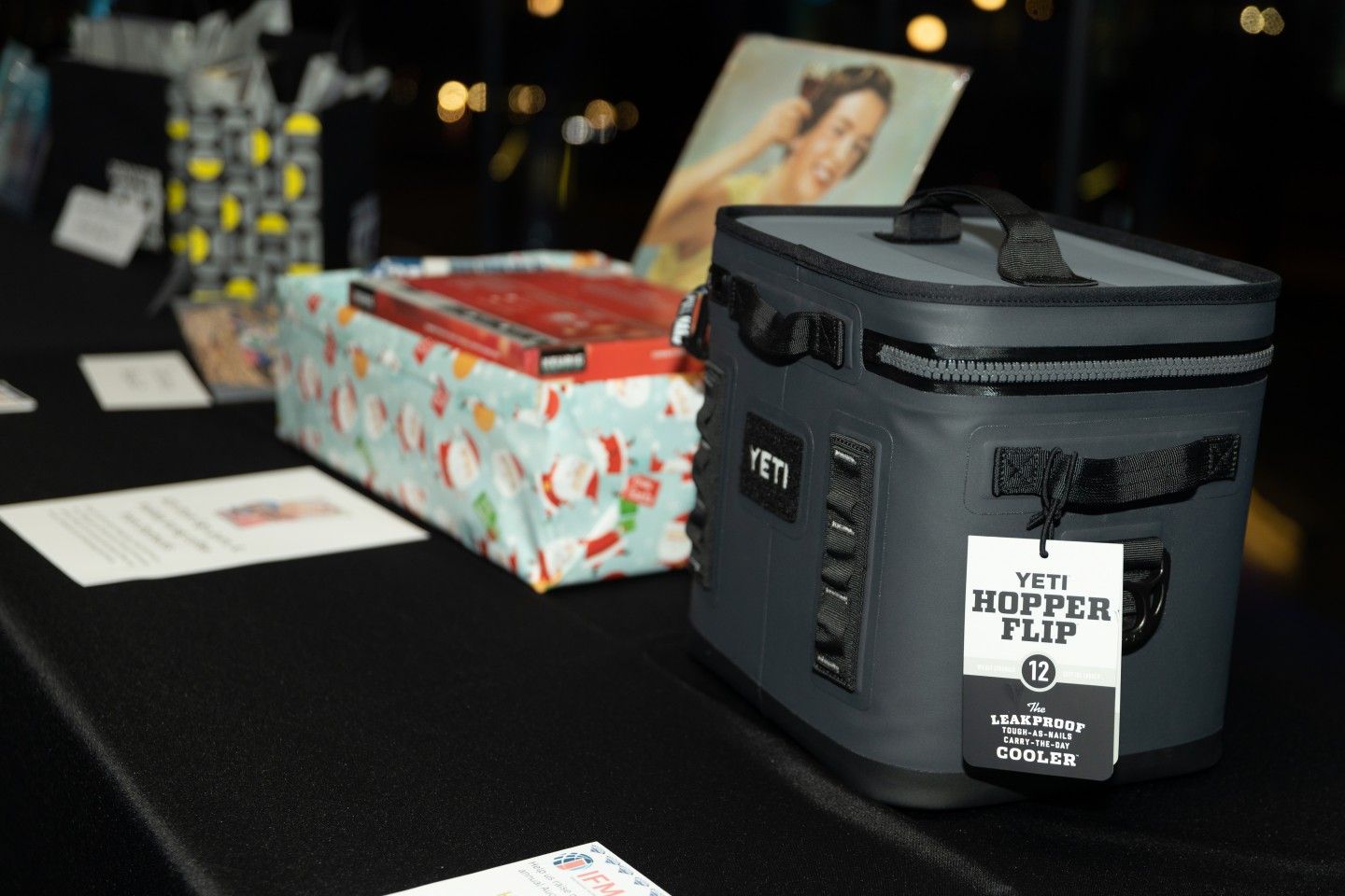 Yeti Hopper Flip cooler on table with wrapped gifts and art in the background.
