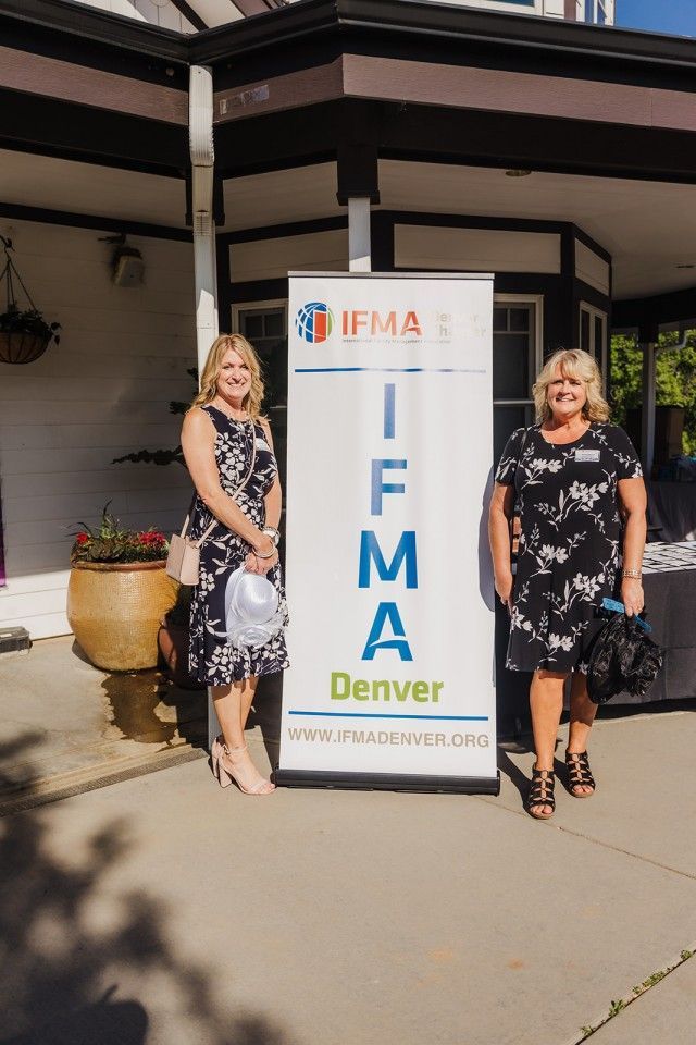 Two women stand beside an