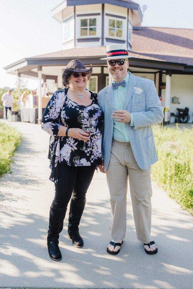Couple posing outdoors in front of a building.