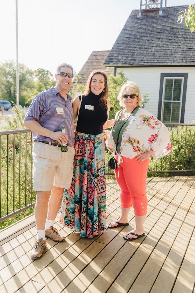 Three people smiling outdoors