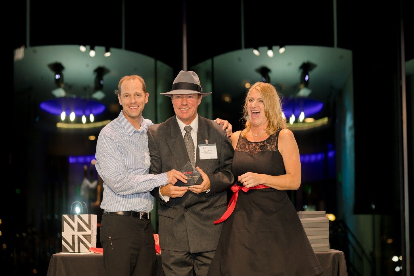 Three people on a stage