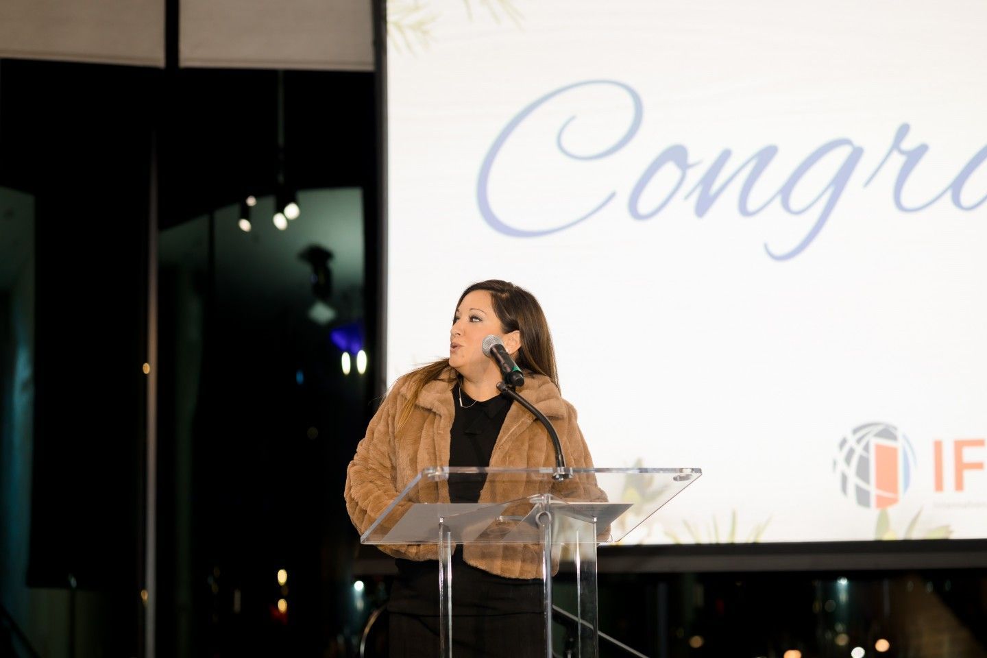 Woman speaking at podium, 