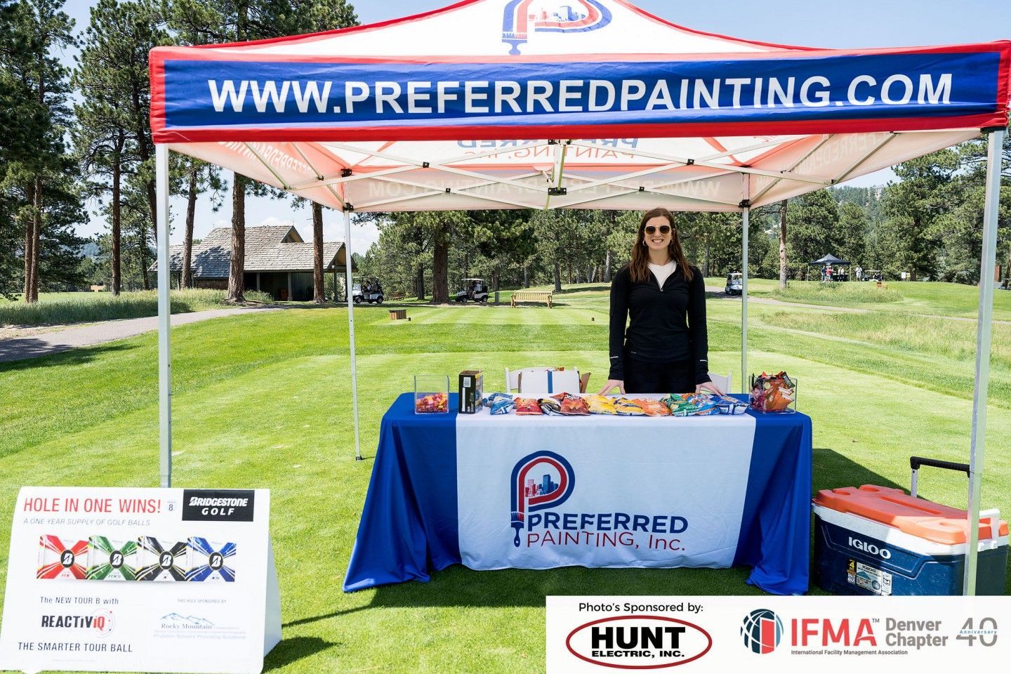 Woman at a Preferred Painting Inc. booth at an outdoor event