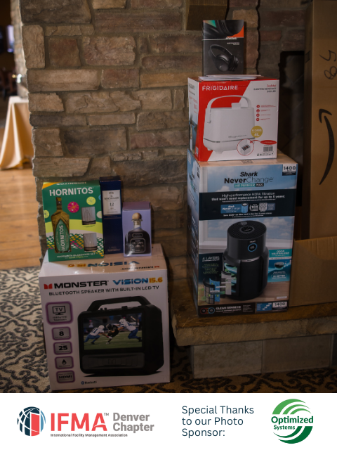 Gifts stacked on a stone hearth including electronics, alcohol, and a Bluetooth speaker.