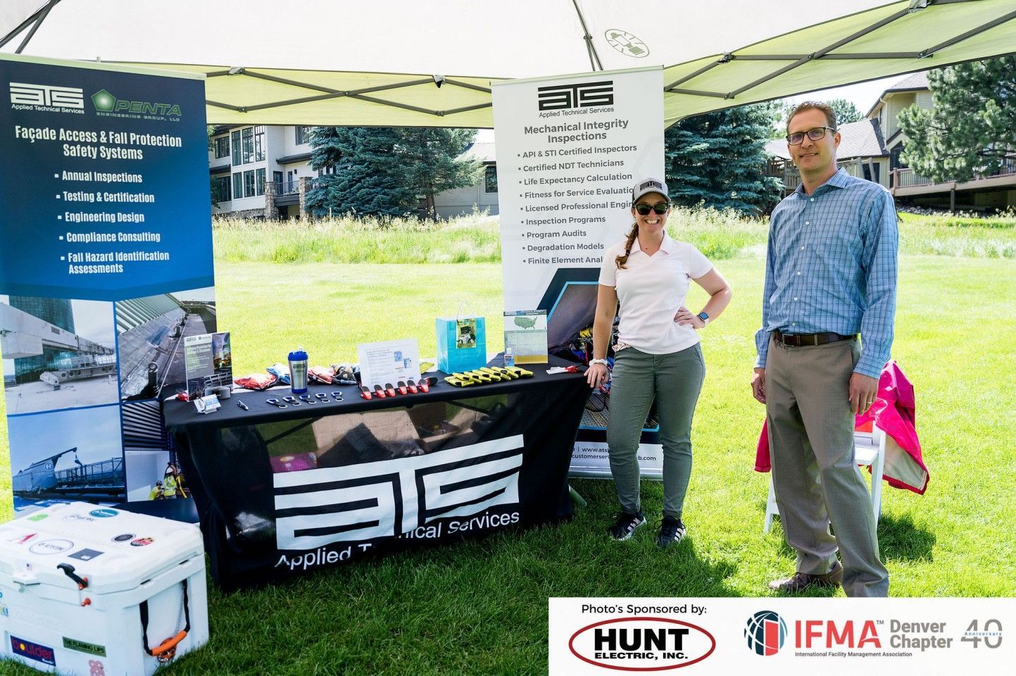 People at booth with banner for 