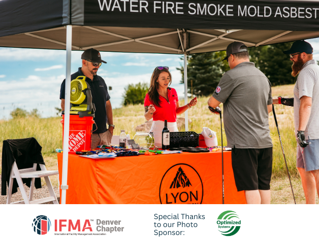 People at a booth with tools and displays, under a tent that says