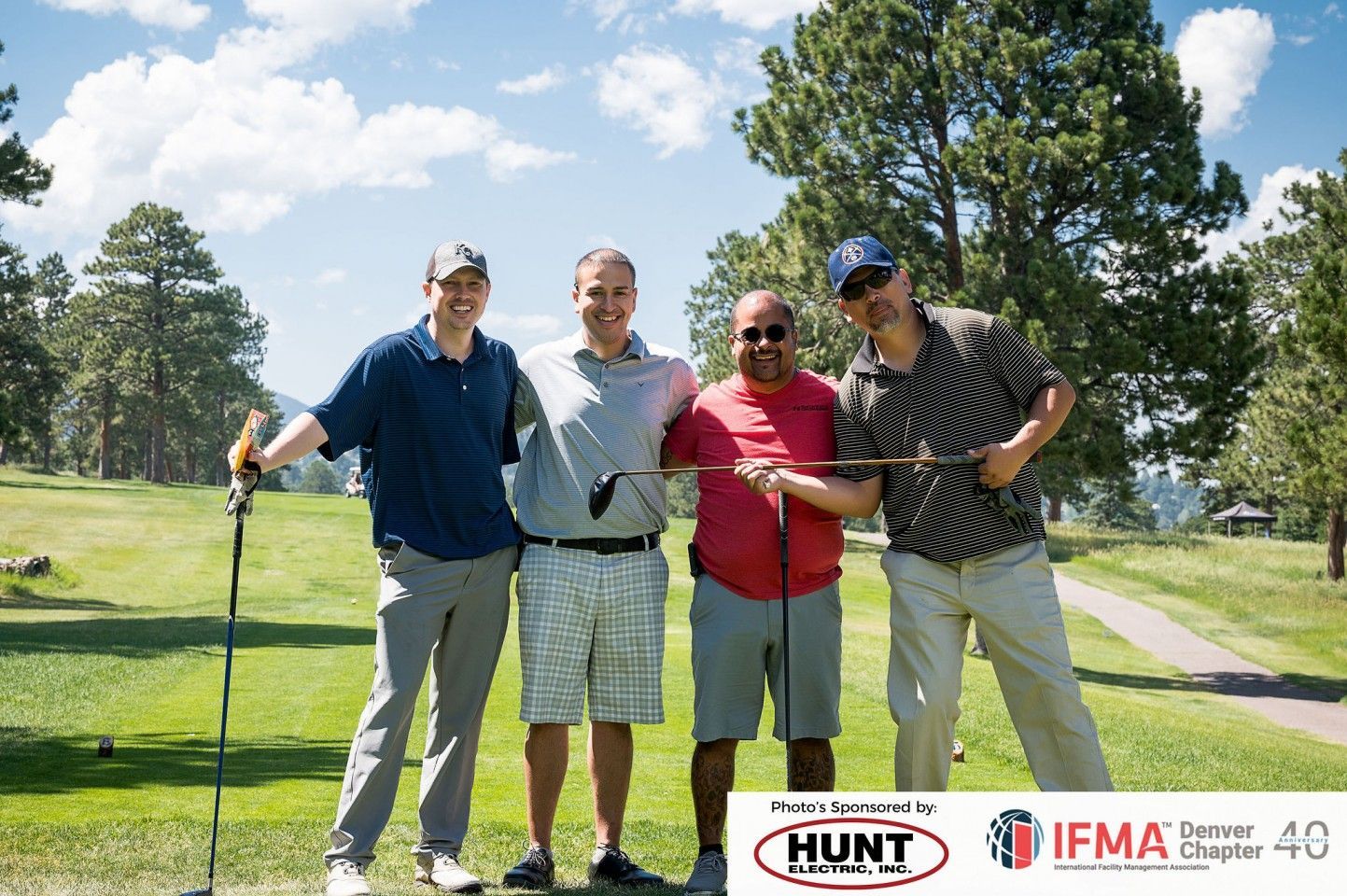 Four golfers pose on a green golf course, smiles. Logo at the bottom: Hunt and IFMA Ohio Chapter 40.