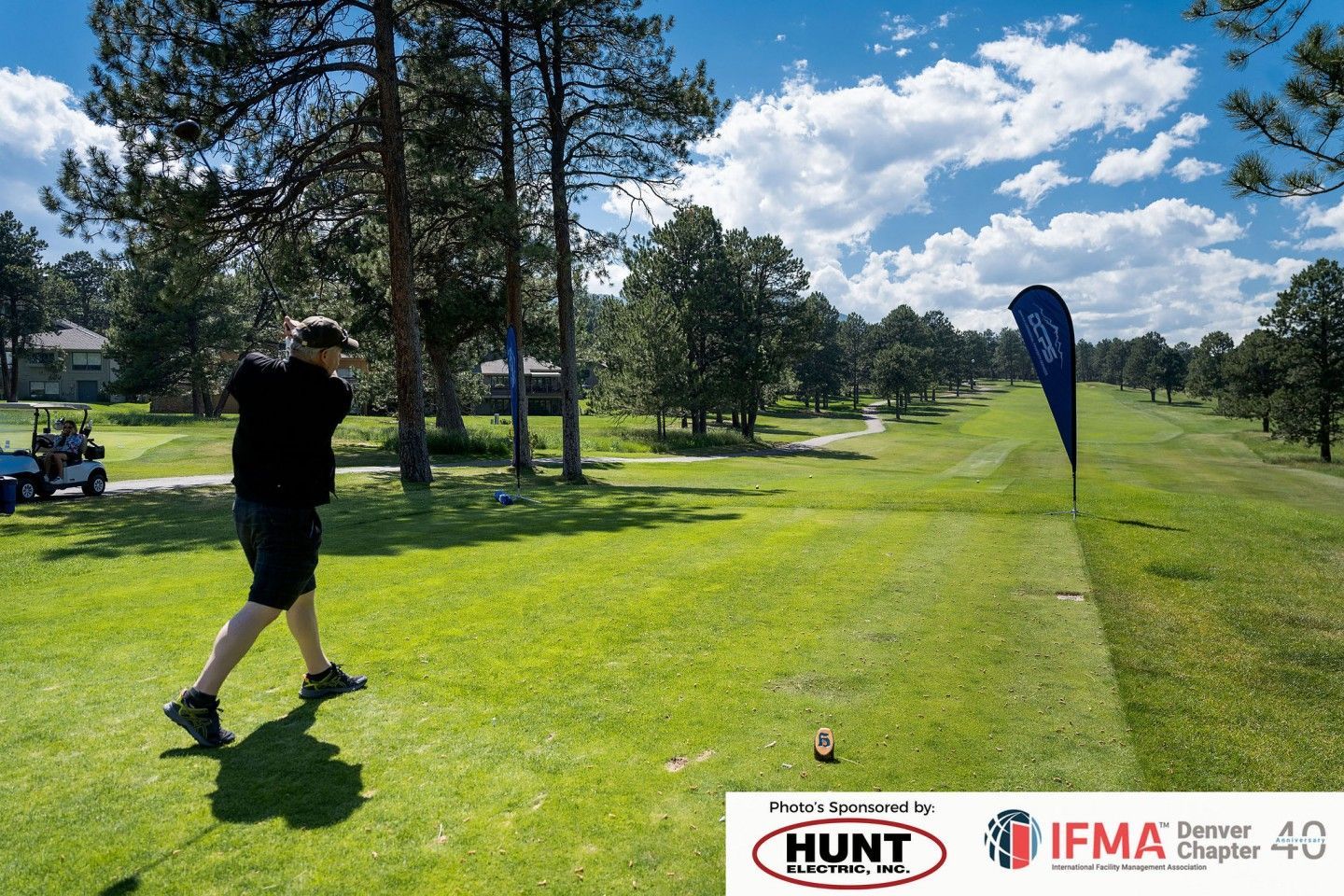 Golfer swinging at tee-off on a sunny golf course; green grass, trees, blue sky, promotional banner.