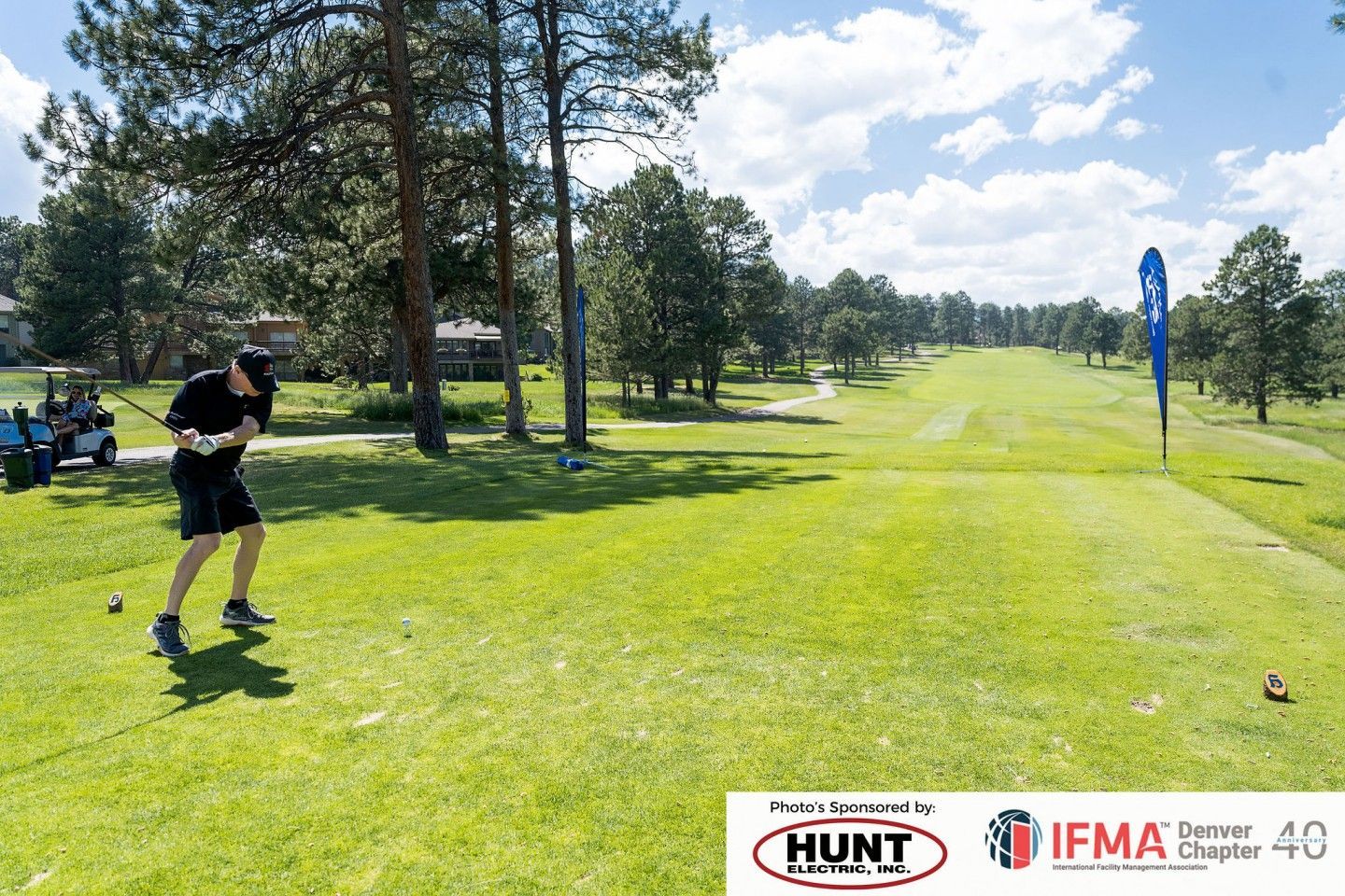 Man teeing off on a golf course. Green grass, trees, blue sky. Logo for 