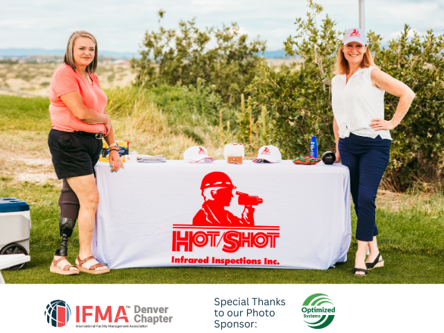 Two women stand behind a table with
