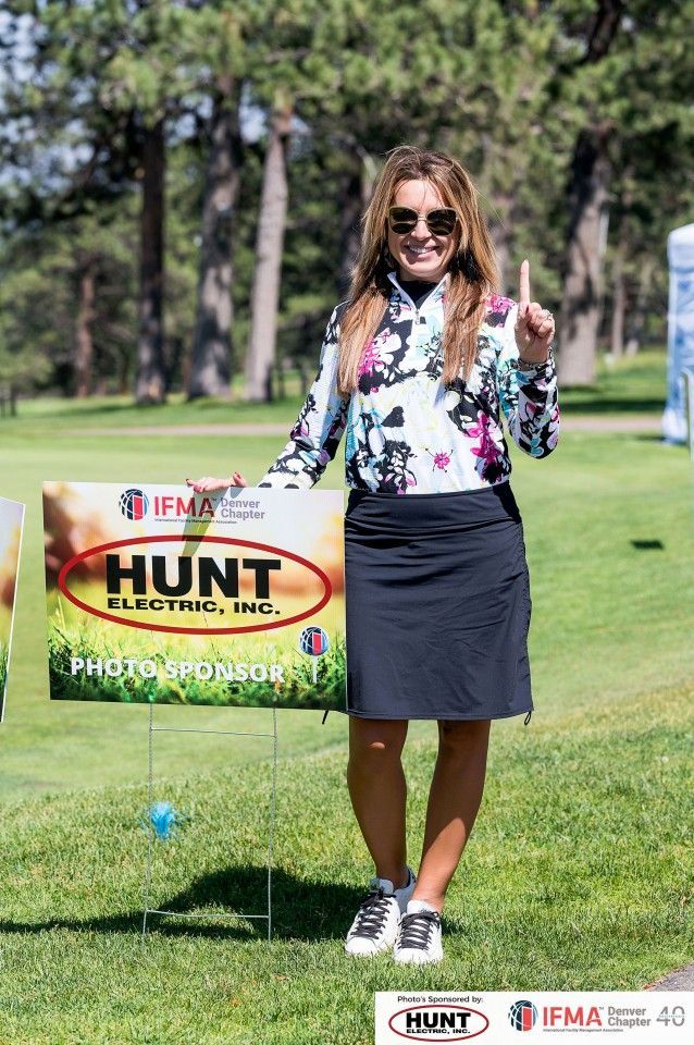 Woman holding up one finger next to a 