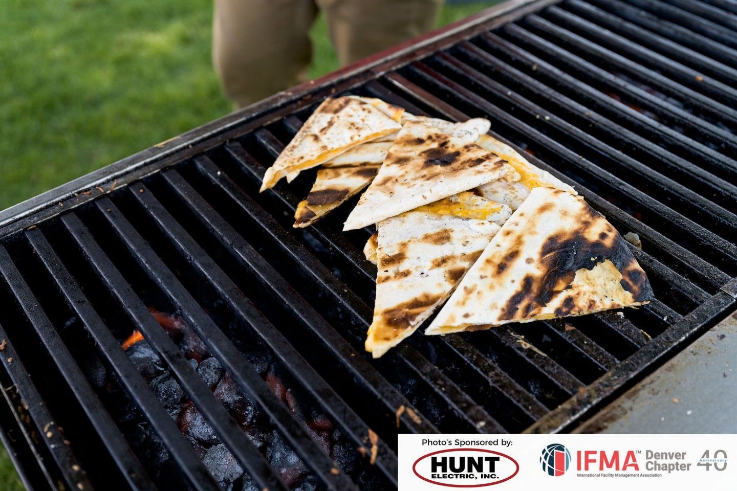 Grilled quesadillas on a hot grill; charred marks visible.