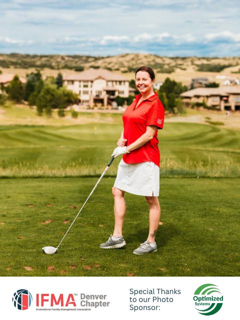 Woman on golf course in red shirt and white skirt, holding a golf club.