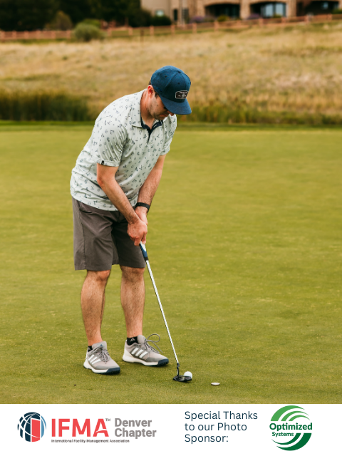 Man putting a golf ball on a green.