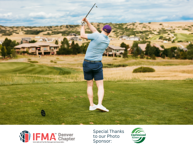 Golfer swinging club on a green course with scenic views.