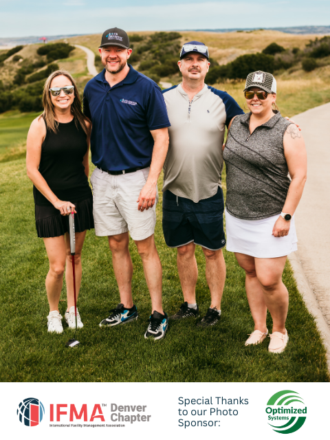Four people pose on a golf course: two men and two women. The background shows grassy hills.