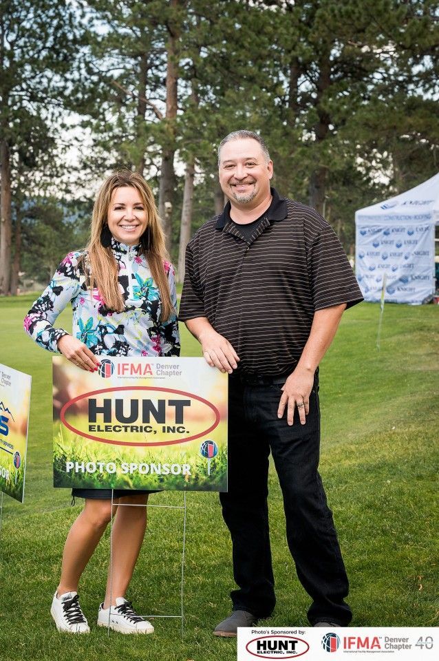 Two people standing with a sign that reads 