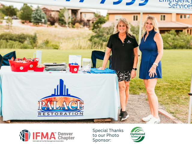 Two women stand behind a table