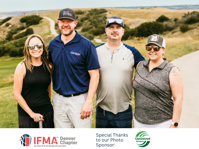 Four people smiling on a golf course. Two men wear hats. Green grass, blue sky, and a logo are in the corner.