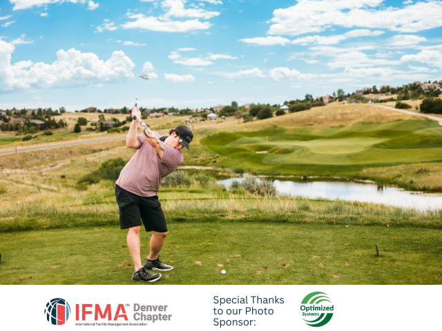 Man swinging a golf club on a green course, blue sky with clouds in the background.