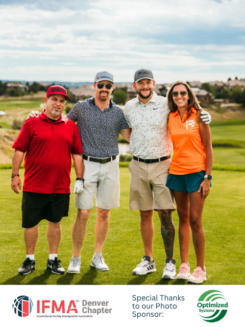 Four people pose on a golf course, smiling with arms around each other.