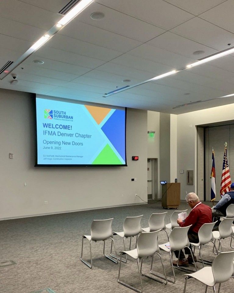 A conference room with a screen displaying 