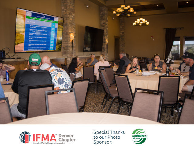 People seated at round tables in a room with screens; IFMA Denver Chapter logo visible.