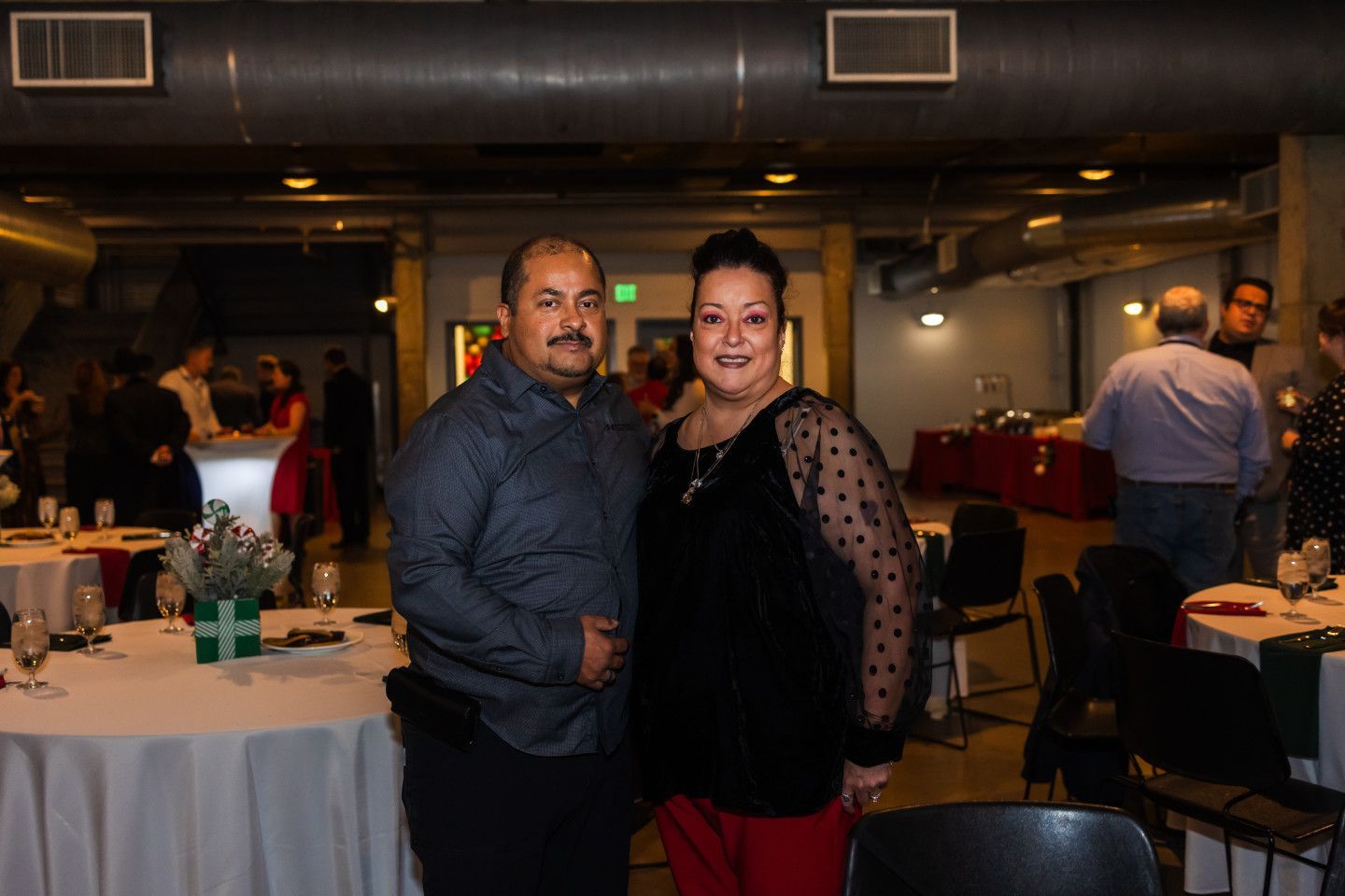 Two people smiling at a party.