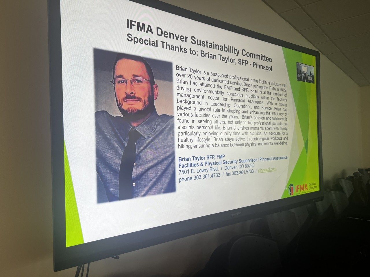 Presentation screen with portrait of a man, text thanking him for work on a sustainability committee.