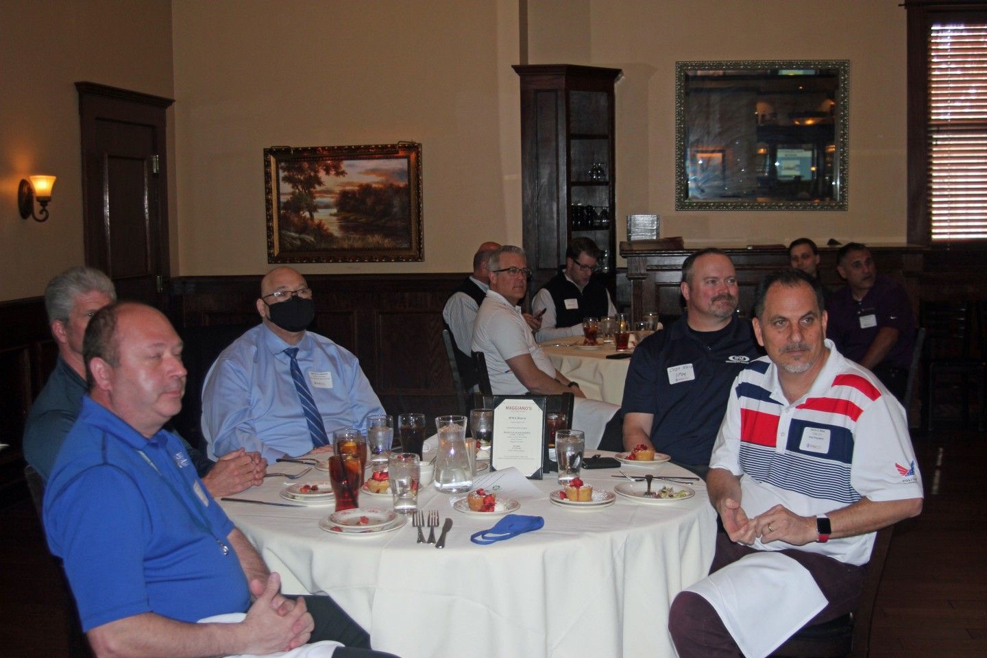 People seated around a round table at a business meeting in a restaurant.