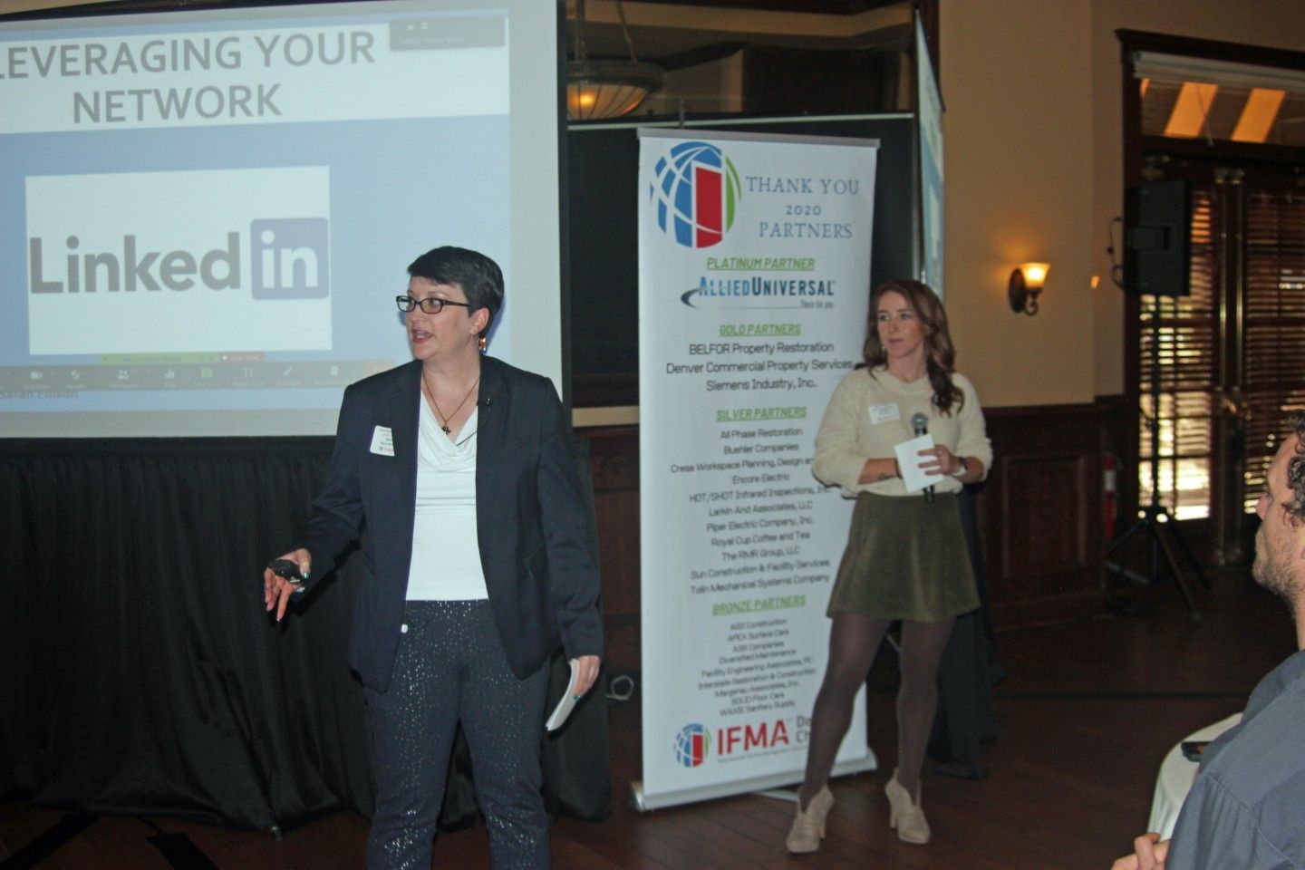 Two women presenting at a networking event.