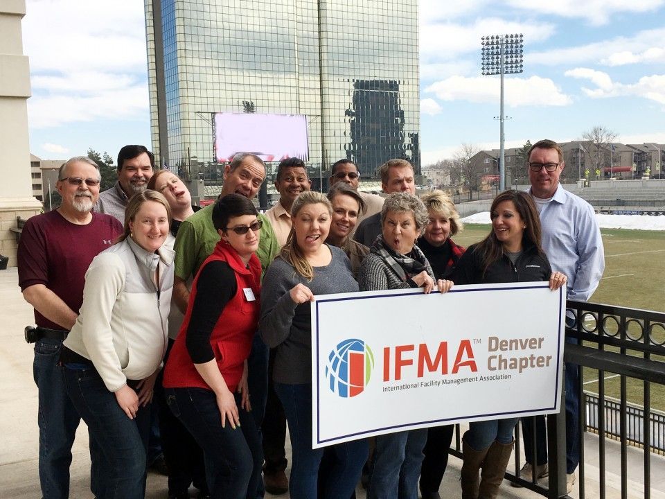 Group of people holding a sign that reads 