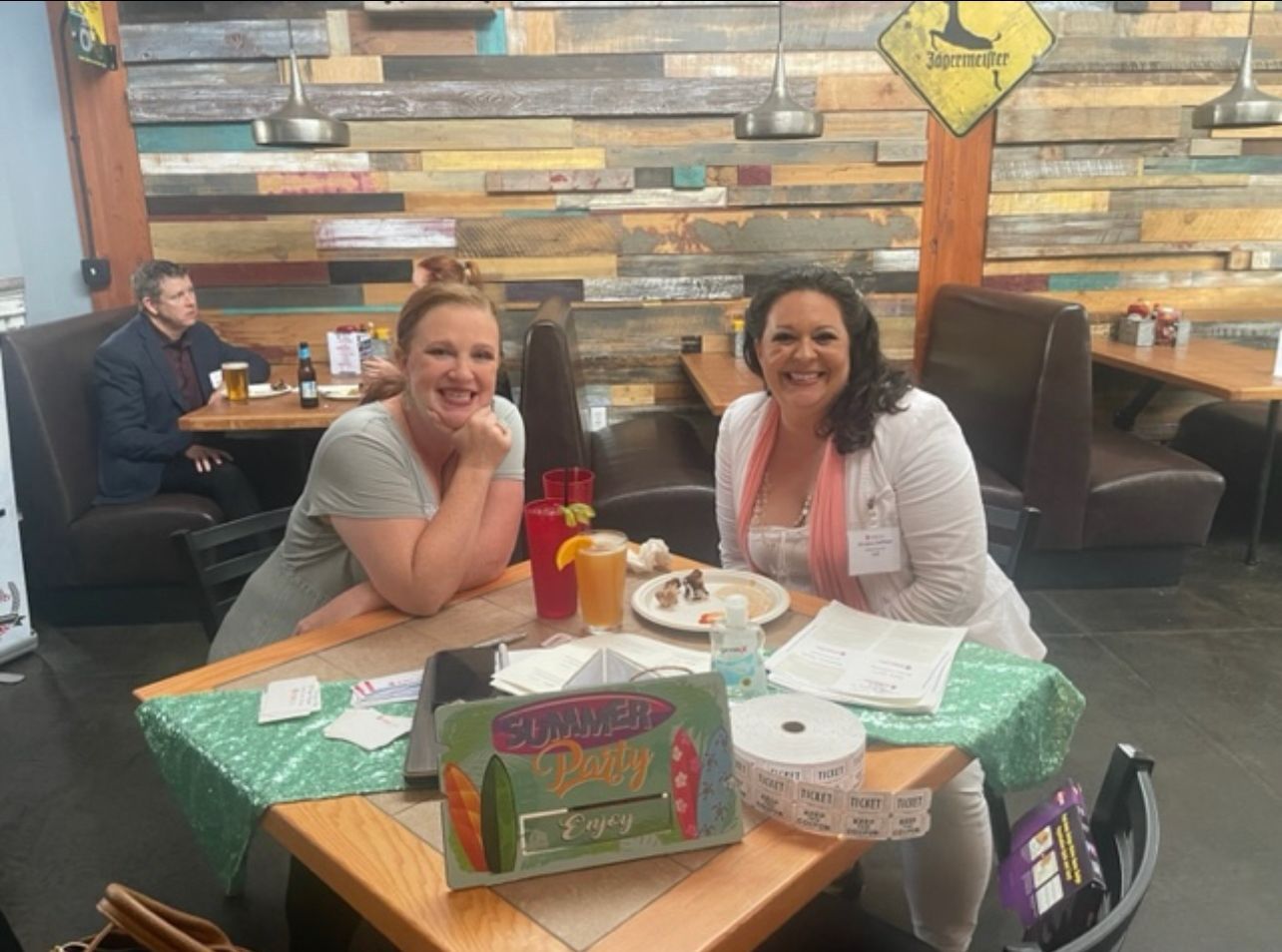 Two women smiling at a table
