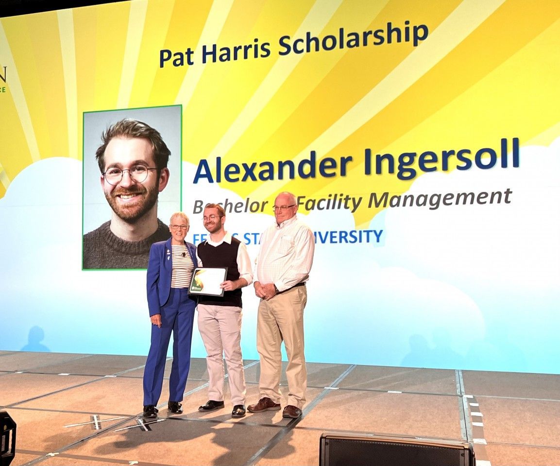 Alexander Ingersoll receives Pat Harris Scholarship at event, holding certificate. Others look on.