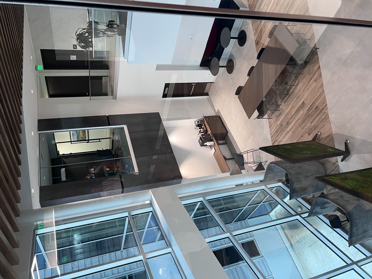 Interior view of a modern building atrium with seating areas and large windows.