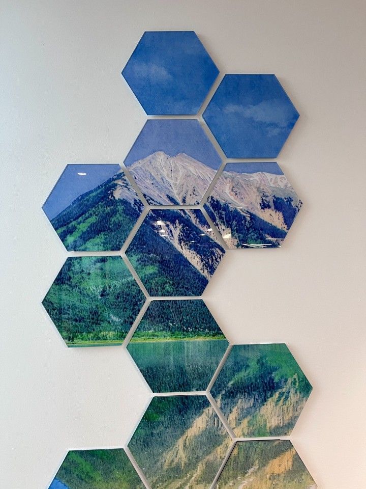Hexagon tiles arranged in a vertical pattern, featuring landscape photos of mountains, sky, and water.