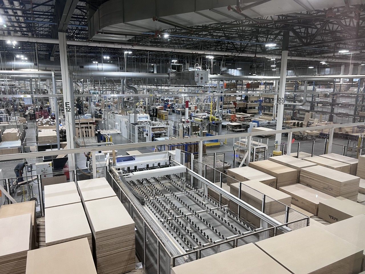 Warehouse interior with cardboard boxes and machinery.