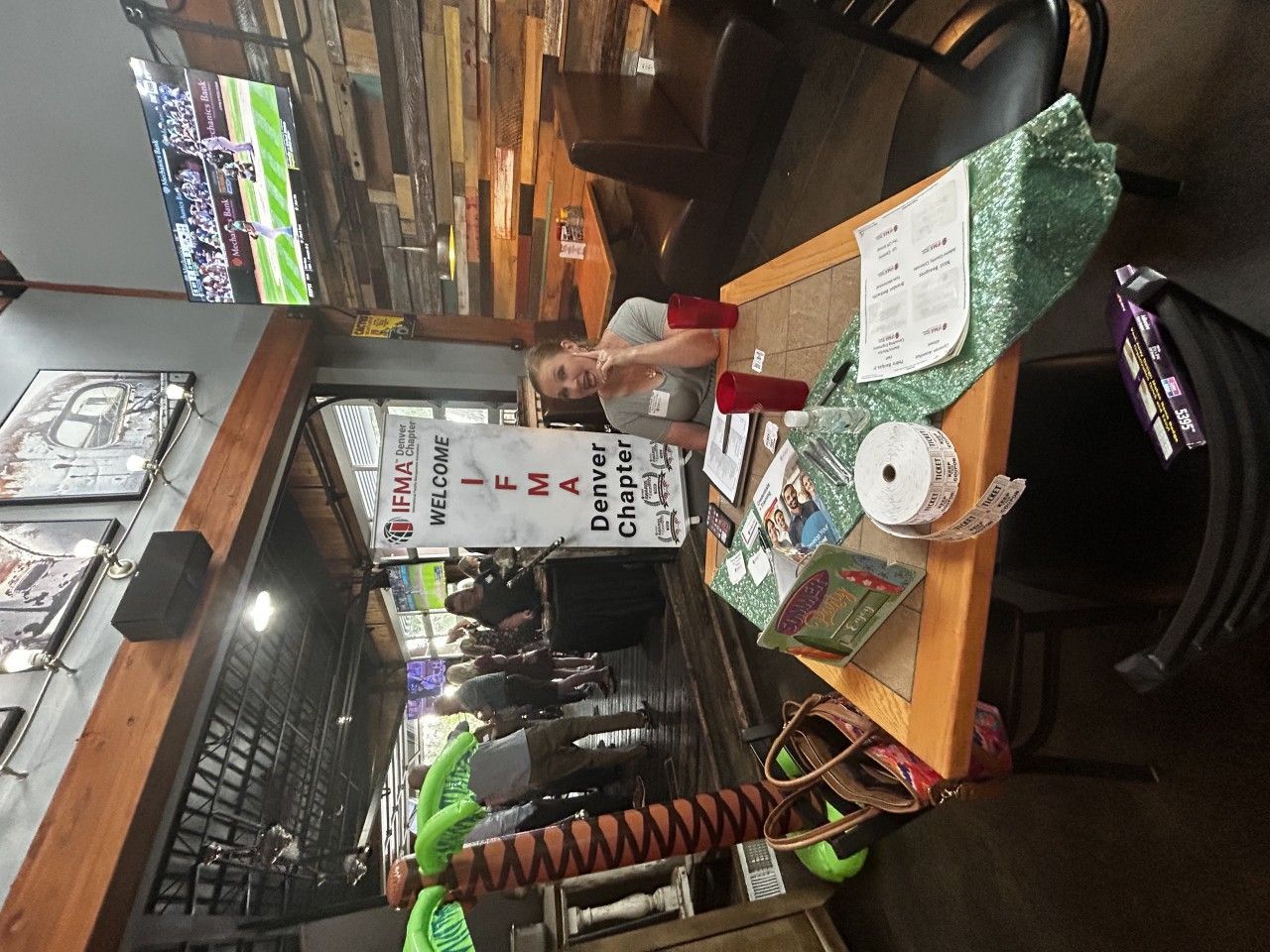 Woman at table with sign