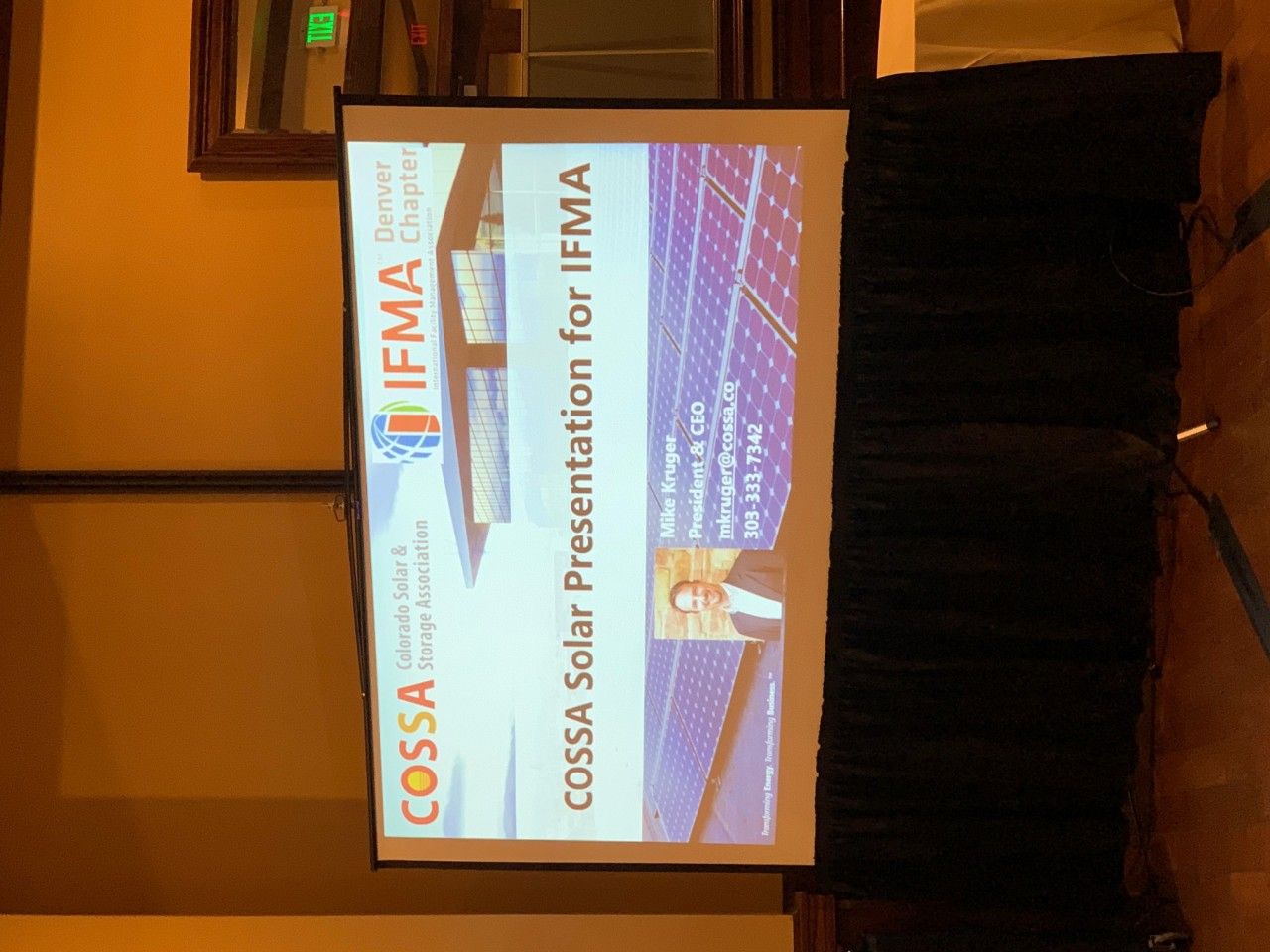 Presentation screen: COSSA solar presentation for IFMA.  A man's photo is shown, with a title, company logo, and details.