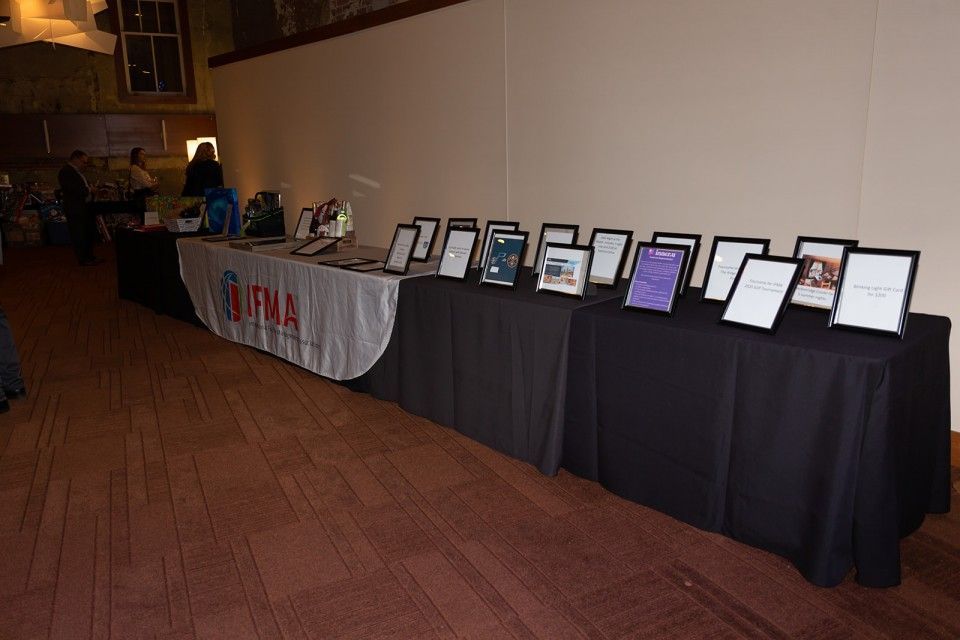 A long table with framed items and a banner that says 
