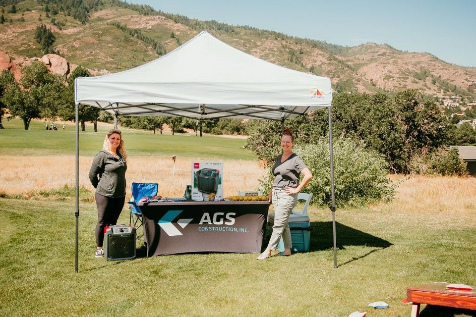 Two women at an outdoor booth with 