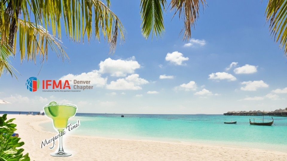 Beach scene with palm leaves, blue sky, turquoise water, white sand, margarita, and IFMA banner.