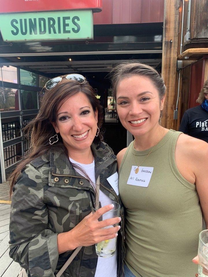 Two smiling women outside a 