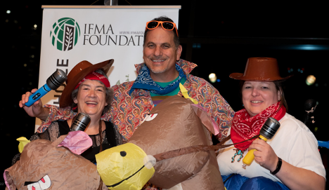 Three people in costume holding microphones