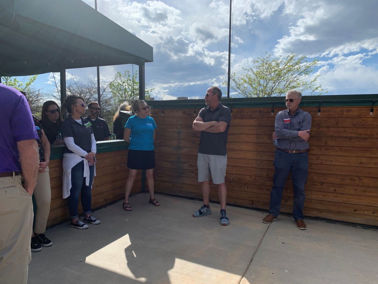 Group of people stand outdoors