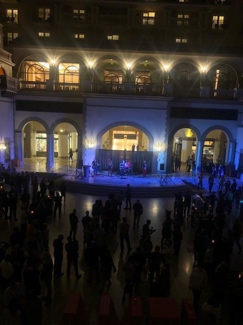 Night scene of a band performing on a stage.