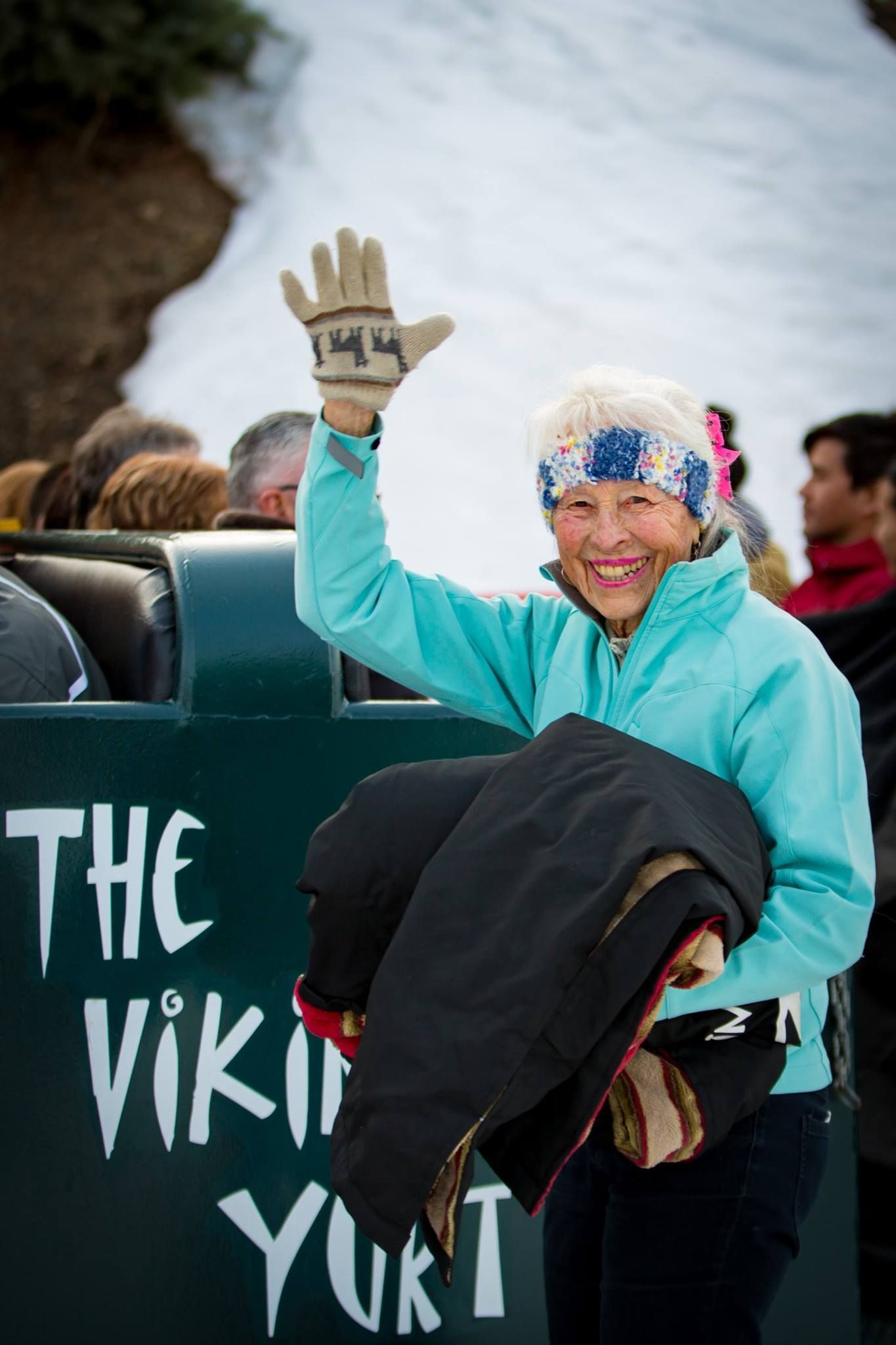 woman waving before getting on the sleigh