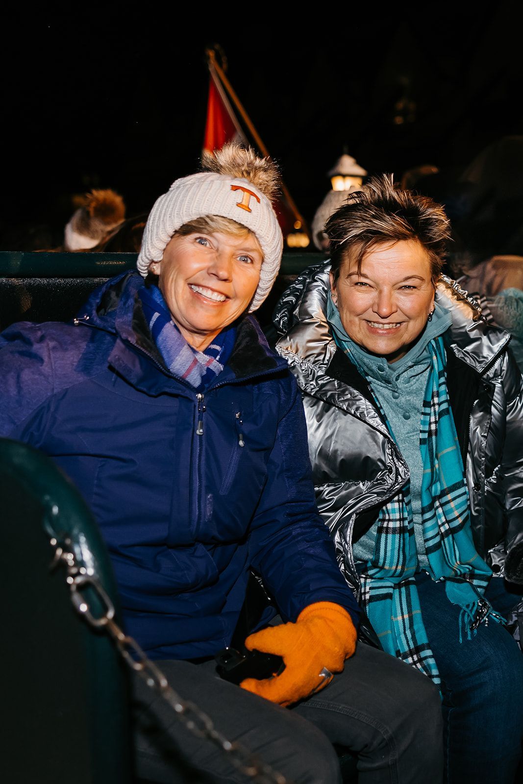 ladies in coats on sleigh
