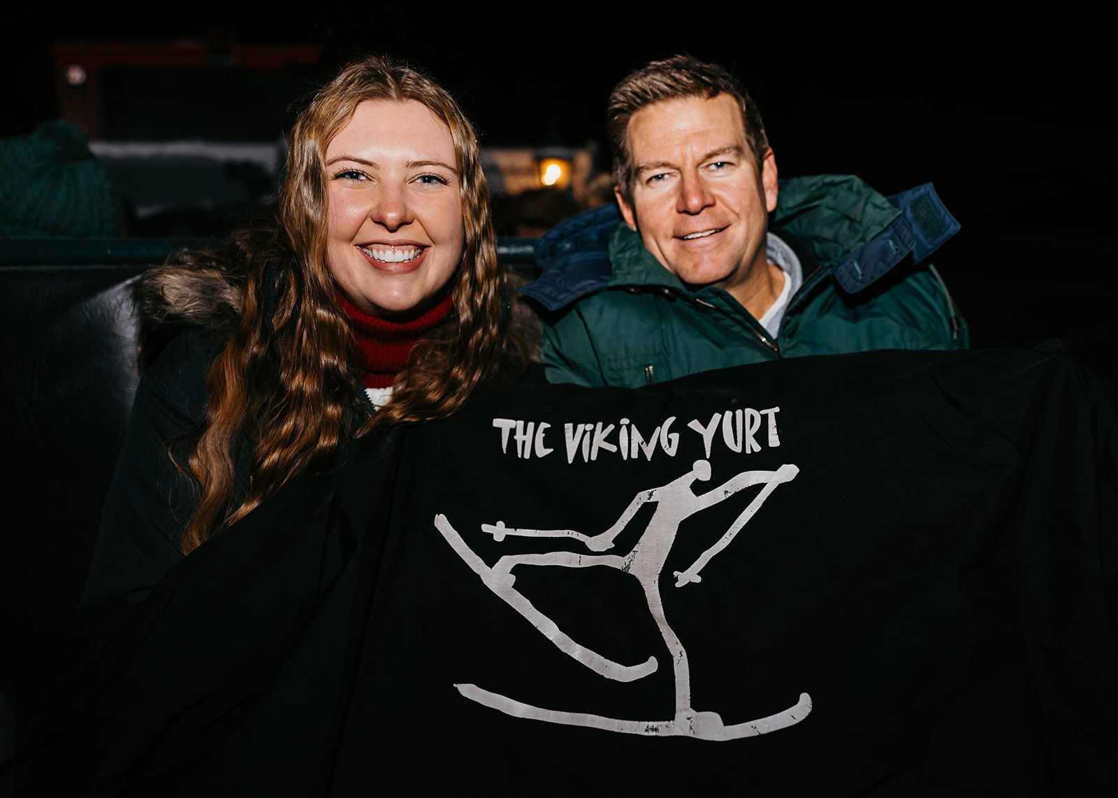 couple under viking yurt blanket on sleigh